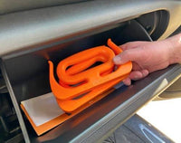 MAMMOTH GRIP Heavy Duty Carrier stored in a car glove box, compact and portable for on-the-go convenience and storage.