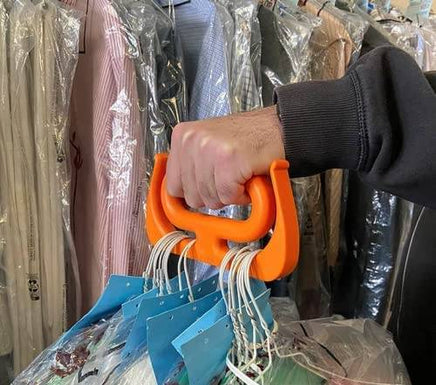 MAMMOTH GRIP Heavy Duty Carrier holding dry cleaning hangers, demonstrating its multipurpose use and strong grip handle.