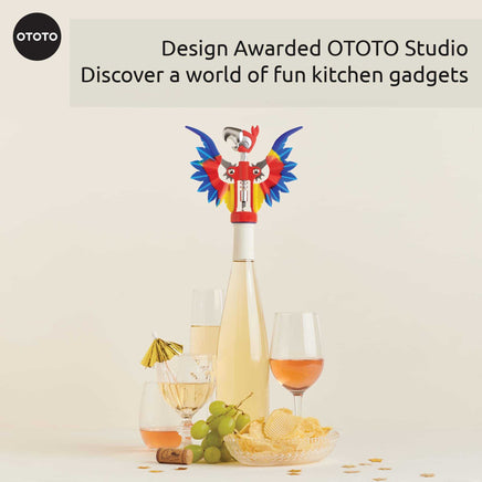 OTOTO Pinot Parrot Opener on a wine bottle with party setup. A design-awarded kitchen gadget that adds fun to any gathering.