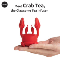 Cute Tea Infuser by OTOTO shaped like a red crab, held in a hand. Fun tea accessory perfect for loose leaf tea and kitchen gifting.