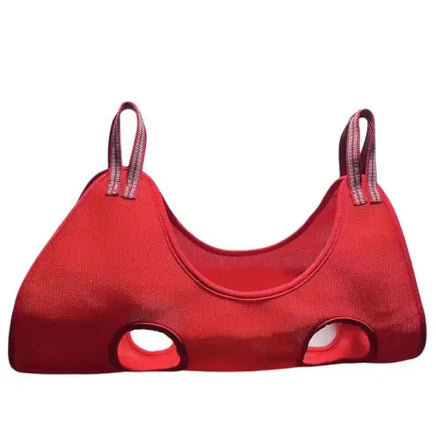 Red pet hammock with reinforced straps and leg openings, designed for grooming and nail trimming. Ideal for cats and small pets.