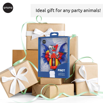OTOTO Pinot Parrot Opener in gift packaging surrounded by wrapped boxes. A perfect gift for party lovers and kitchen gadget fans.