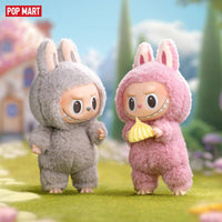 POP MART The Monsters Tasty Macarons Blind Box Figures feature two fuzzy vinyl toys in bunny suits, one holding a yellow macaron. Ideal for collectors.