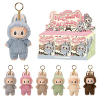 POP MART The Monsters Tasty Macarons Blind Box Figures featuring plush-suited vinyl characters with keychains in assorted pastel colors.