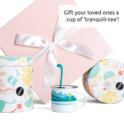 Cute Tea Infuser by OTOTO shaped like a green creature in a white mug with gift packaging, perfect fun tea accessory for loose leaf tea lovers.