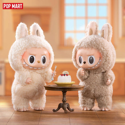 POP MART The Monsters Tasty Macarons Blind Box Figures feature two fluffy bunny-suited vinyl toys standing by a dessert table with a macaron cake.