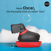 Meet Oscar, the dog-shaped reusable dish brush by Ototo, shown with soap bubbles, a fun and effective kitchen cleaning tool.