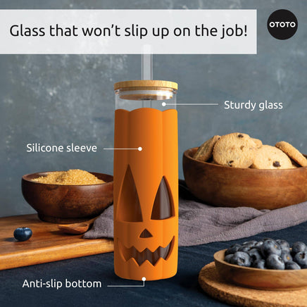 Close-up of Halloween glass coffee tumbler with anti-slip bottom, silicone sleeve, and sturdy glass for safe sipping.