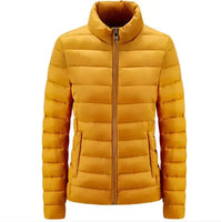 Simple Women's Stand-up Collar Puffer Jacket in mustard yellow with zip-up front and horizontal quilting. A cozy, minimalist winter coat for everyday wear.