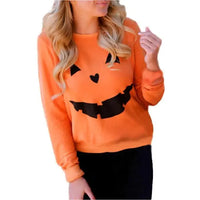 Woman wearing Halloween Pumpkin Sweatshirt - Perfect for Spooky Season, styled casually for autumn with black pants and loose curls.