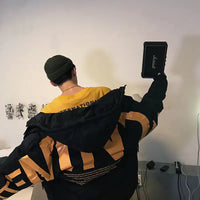 Oversized black and yellow Men's Winter Puffer Jacket with bold text, combining comfort and Korean-style fashion for cold seasons.