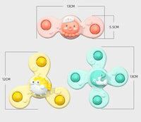 Set of three baby spin toys in yellow, pink, and green with animal designs, showcasing dimensions for size reference.