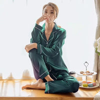 Women Silk Satin Pajamas in emerald green, featuring a button-up top and matching pants. Perfect for luxurious comfort and elegant sleepwear.
