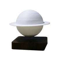 Levitating Saturn lamp in a white matte finish on a wooden base, perfect for minimalist decor.