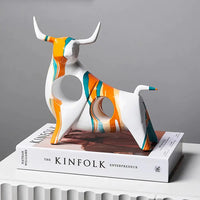 White and orange Modern Art Graffiti Cow Figurine with abstract design, displayed on a minimalist surface for home styling.