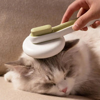 Cat being groomed with a green Automatic Hair Remover & Massage Comb, illustrating its gentle and effective grooming.