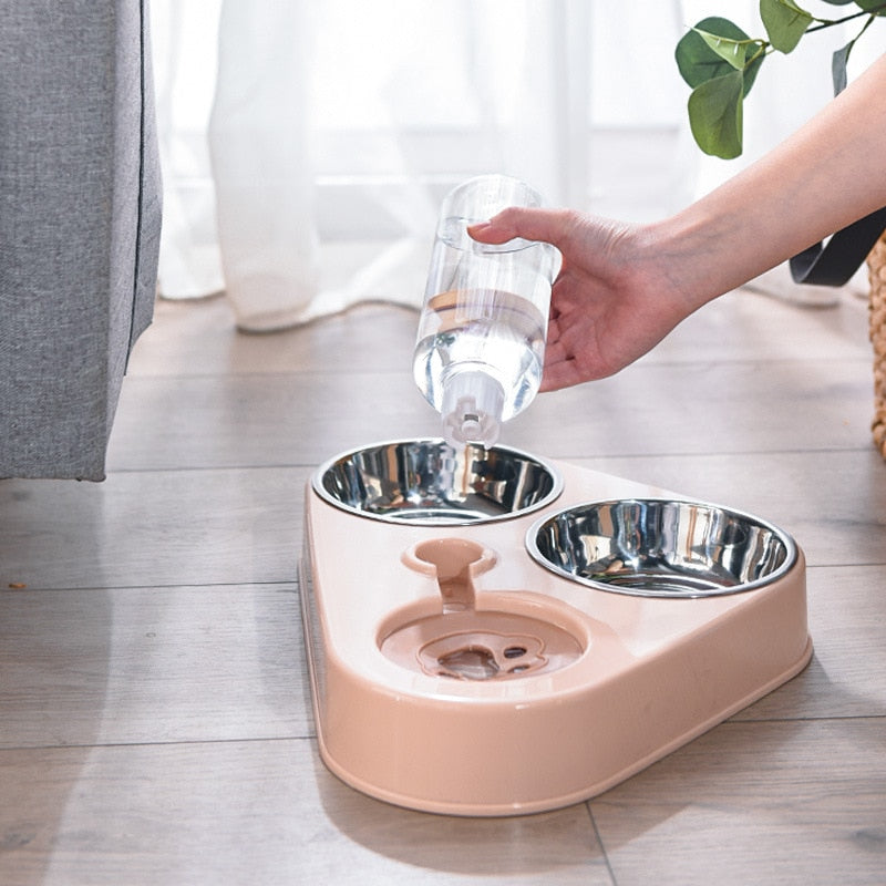 Hand placing water bottle into pink 3in1 Pet Food Bowl with dual food compartments and automatic hydration system for pets.