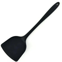 Black silicone spatula with a long handle, perfect for flipping and serving food in the kitchen.