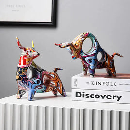 Modern Art Graffiti Cow Figurines featuring vibrant multicolor designs, displayed on books for contemporary home decor.