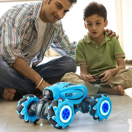 Father and son playing with a blue RC stunt car featuring LED wheels and an advanced suspension system indoors.