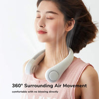 Woman wearing Mini Bladeless Neck Fan Outdoor with visible airflow, demonstrating 360° cooling and hands-free operation for outdoor comfort.