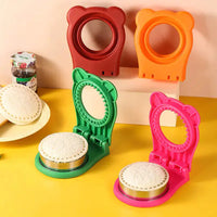 Set of colorful stainless steel sandwich cut molds in red, orange, green, and pink, displayed with round toast pockets and jam jar.