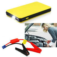 Yellow multifunctional portable emergency power bank with LED light, USB ports, and jumper cables for car battery jump-starting.