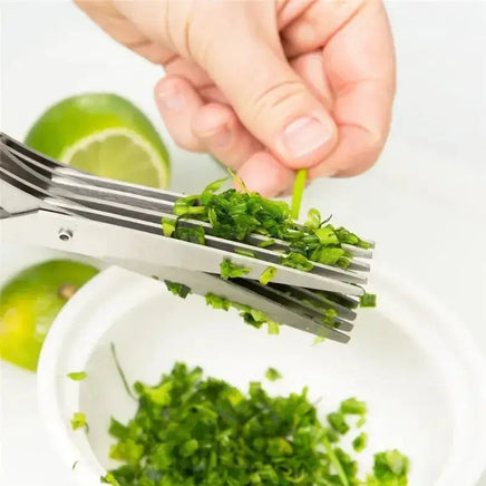 Hand using multifunctional green onion scissors to cut fresh herbs into a bowl, showcasing its precision and ease of use.