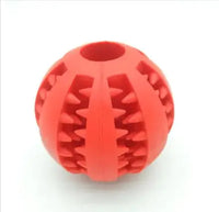 Red interactive rubber slow feeder dog ball with textured grooves for treat dispensing and chewing fun.