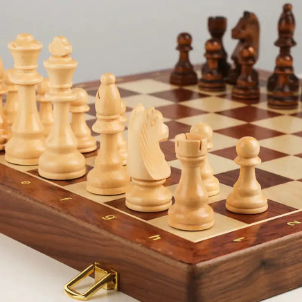 Close-up of light wooden chess pieces on a chessboard with engraved coordinates, part of the Large Children's Wooden Folding Chess Set.