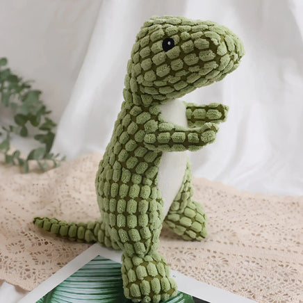 Green dinosaur plush dog toy with a soft and textured design, great for interactive pet play.