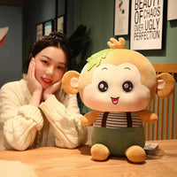 Yellow Sitting Monkey Plush Toy on a table with a woman posing beside it, emphasizing its adorable design.