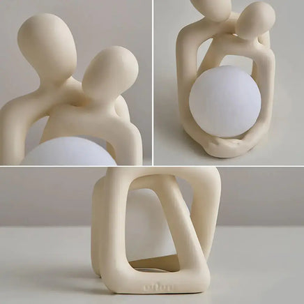 Close-up of a Nordic couple statue showcasing its smooth design and glowing orb feature for home decor.