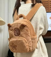 Capybara Plush Little Backpack worn by a person, highlighting its adjustable straps, compact size, and charming capybara-themed design.