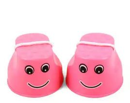 Pink children's outdoor stilts with smiley face design and rope handles for fun balance training and motor skill development.