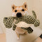 Shiba Inu holding a green dinosaur plush dog toy, designed for playful and interactive fun for pets.