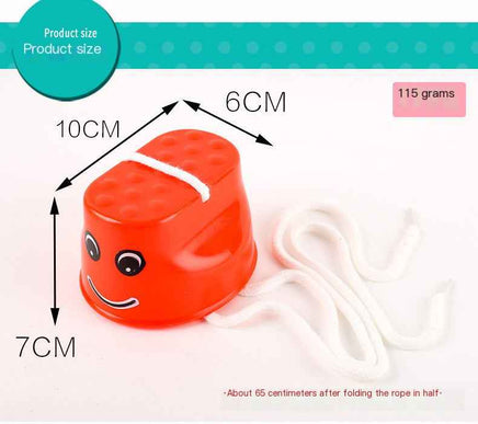 Red children's outdoor stilt with dimensions labeled, featuring a smiley face and rope for balance training and coordination play.