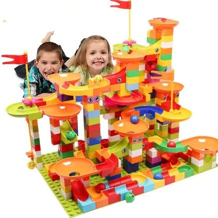 Children playing with a large marble race run block toy set featuring colorful blocks, slides, and creative design.