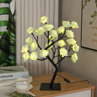 Romantic Rose Tree Lamp with glowing yellow roses, placed on a wooden desk, enhancing bedroom decor with a warm ambiance.