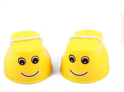 Yellow children's outdoor stilts with smiley face and rope handles, designed for safe and engaging balance training for kids.