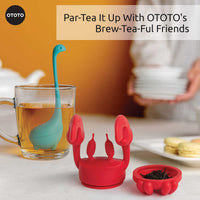 Cute Tea Infuser by OTOTO shaped like a red crab and blue dinosaur, perfect for loose leaf tea. Fun tea accessory ideal for gifting or kitchen use.