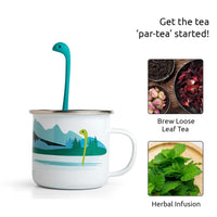 Cute Tea Infuser by OTOTO shaped like a sea monster in a white mug with mountain design, ideal for brewing loose leaf or herbal tea.