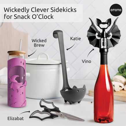 Halloween kitchen accessories featuring Wicked Brew tumbler, bat-shaped scissors, and spooky utensils for themed snack time.