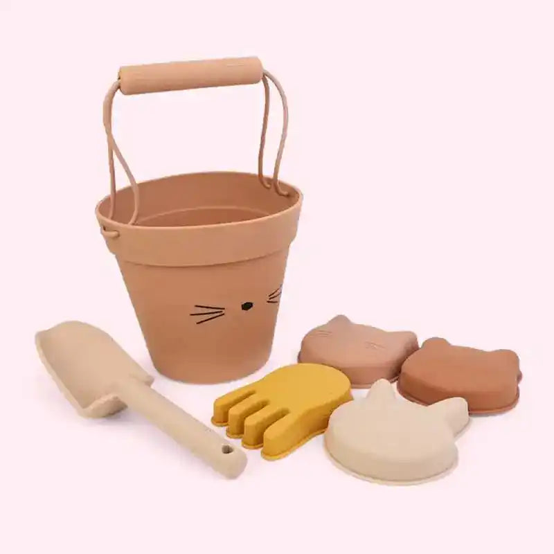Beige cat-themed beach toy set with a bucket, shovel, and animal-shaped sand molds, ideal for children's summer fun at the beach.