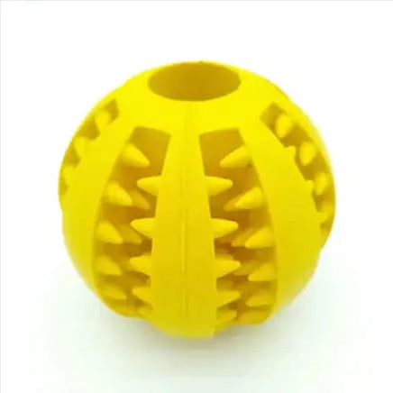 Yellow interactive rubber slow feeder dog ball with textured grooves for treat dispensing and chewing fun.