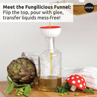Fungilicious Funnel from Ototo Forest Trio shown pouring oil mess-free, designed as a red mushroom cap for whimsical kitchen use.