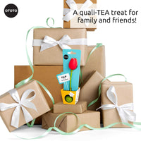 Cute Tea Infuser by OTOTO shaped like a red tulip, displayed among gift-wrapped boxes. Fun tea accessory perfect for loose leaf tea lovers.