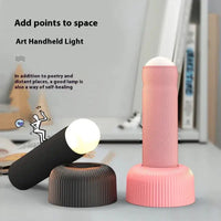 Black and pink hand pull night lamps displayed on a desk, highlighting their modern design and versatility for home decor.