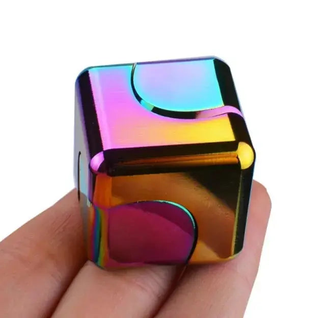 Rainbow-colored fidget spinner stress relief cube held in hand, designed for anxiety relief and improved focus.