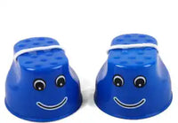 Blue children's outdoor stilts with happy face design and white rope handles, promoting coordination and motor skill development.